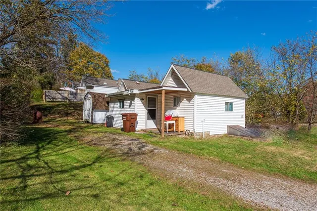 a view of a house with a yard and tree s