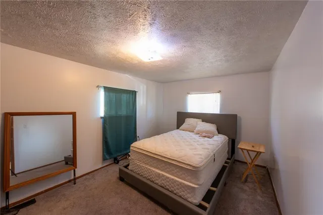 a bedroom with a bed and a mirror