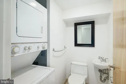 a white toilet sitting next to a bathroom sink