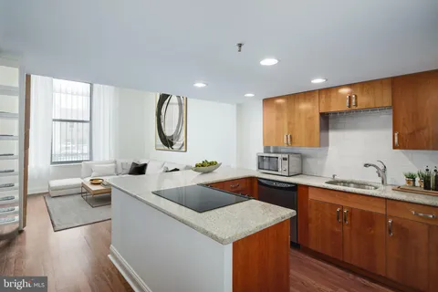 a kitchen with a sink dishwasher a stove and a refrigerator with wooden floor