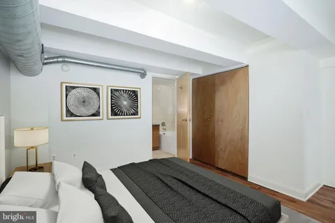 a bedroom with a bed and wall painting