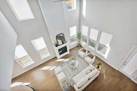 a living room with furniture and a floor to ceiling window