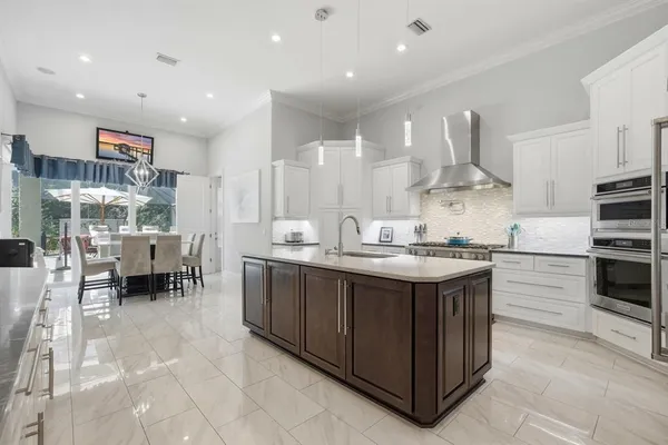 a kitchen with granite countertop a sink and cabinets