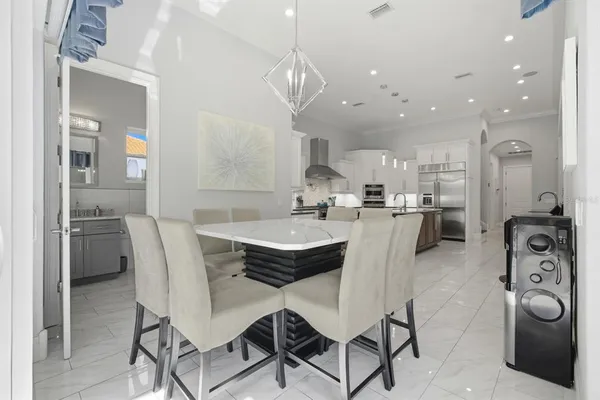 a bedroom with a bed painting and a large window