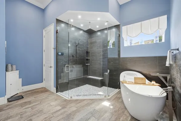 a bedroom with a bed and a large window with the outer view