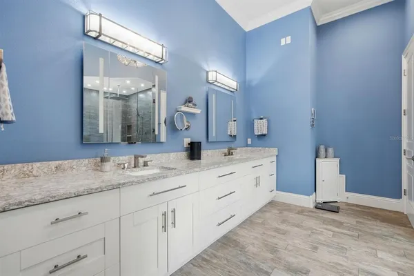 a bathroom with a granite countertop sink a mirror and a shower