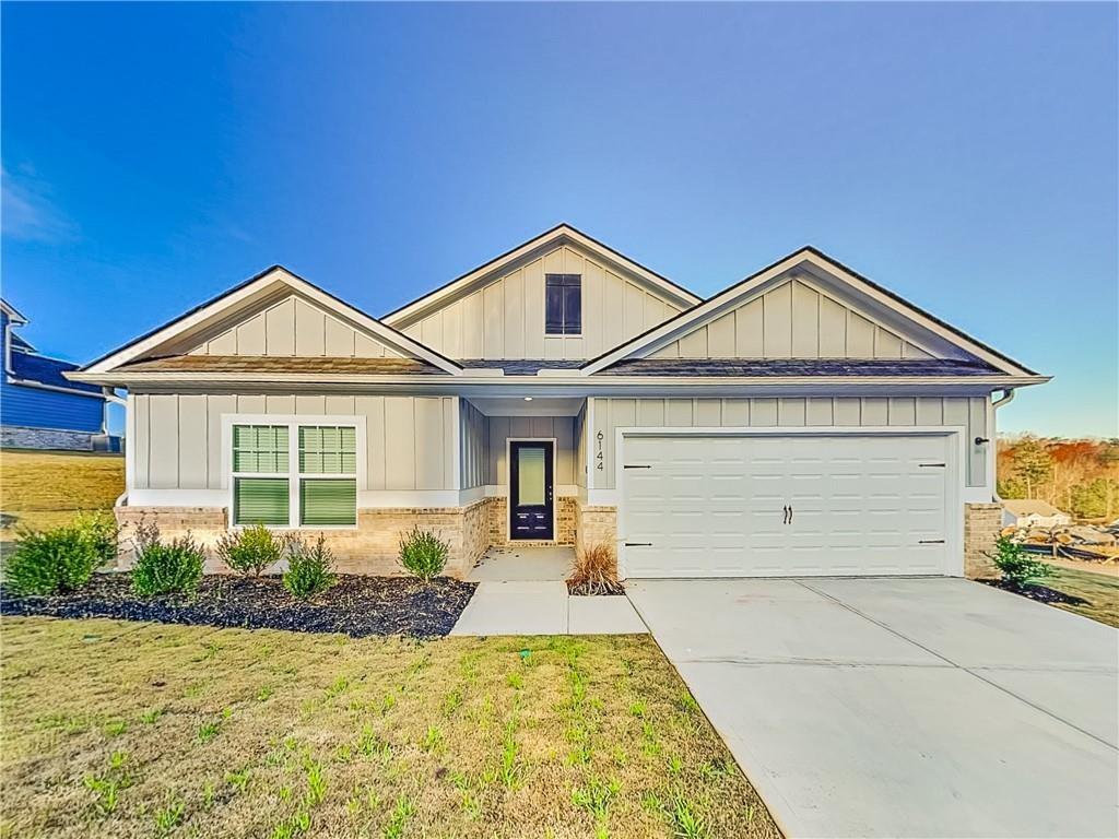 6144 Nathaniel Lane Fairburn, GA 30213 - Photo 1 of 1 a front view of a house with a yard and garage