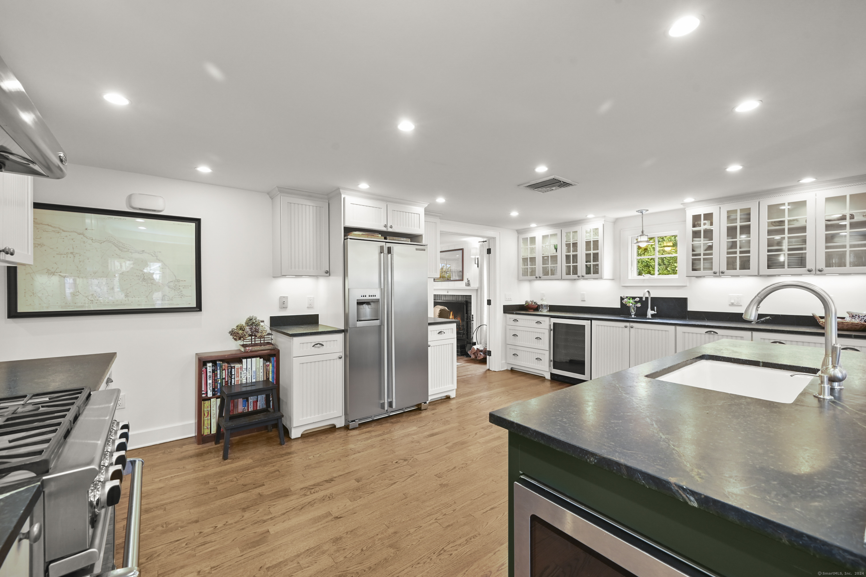 104 Roton Avenue Norwalk, CT 06853 - Photo 10 of 40 a kitchen with refrigerator and chairs