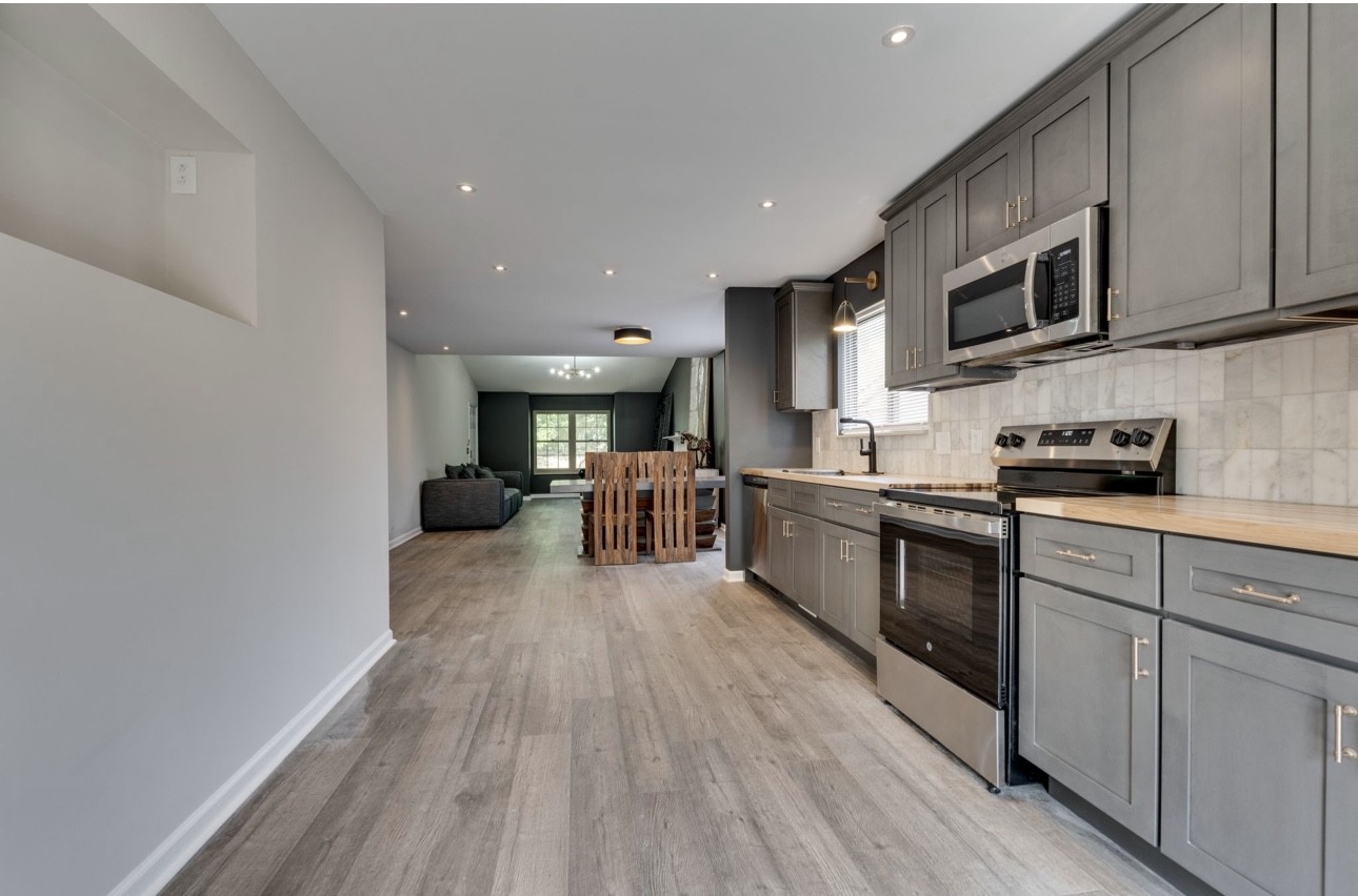 515 Upsall Drive Antioch, TN 37013 - Photo 11 of 31 a kitchen with stainless steel appliances granite countertop a stove top oven a sink with wooden cabinets and floors