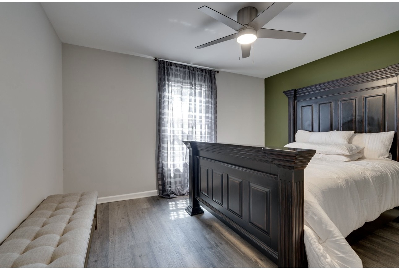 515 Upsall Drive Antioch, TN 37013 - Photo 18 of 31 a bed room with a bed and a chandelier