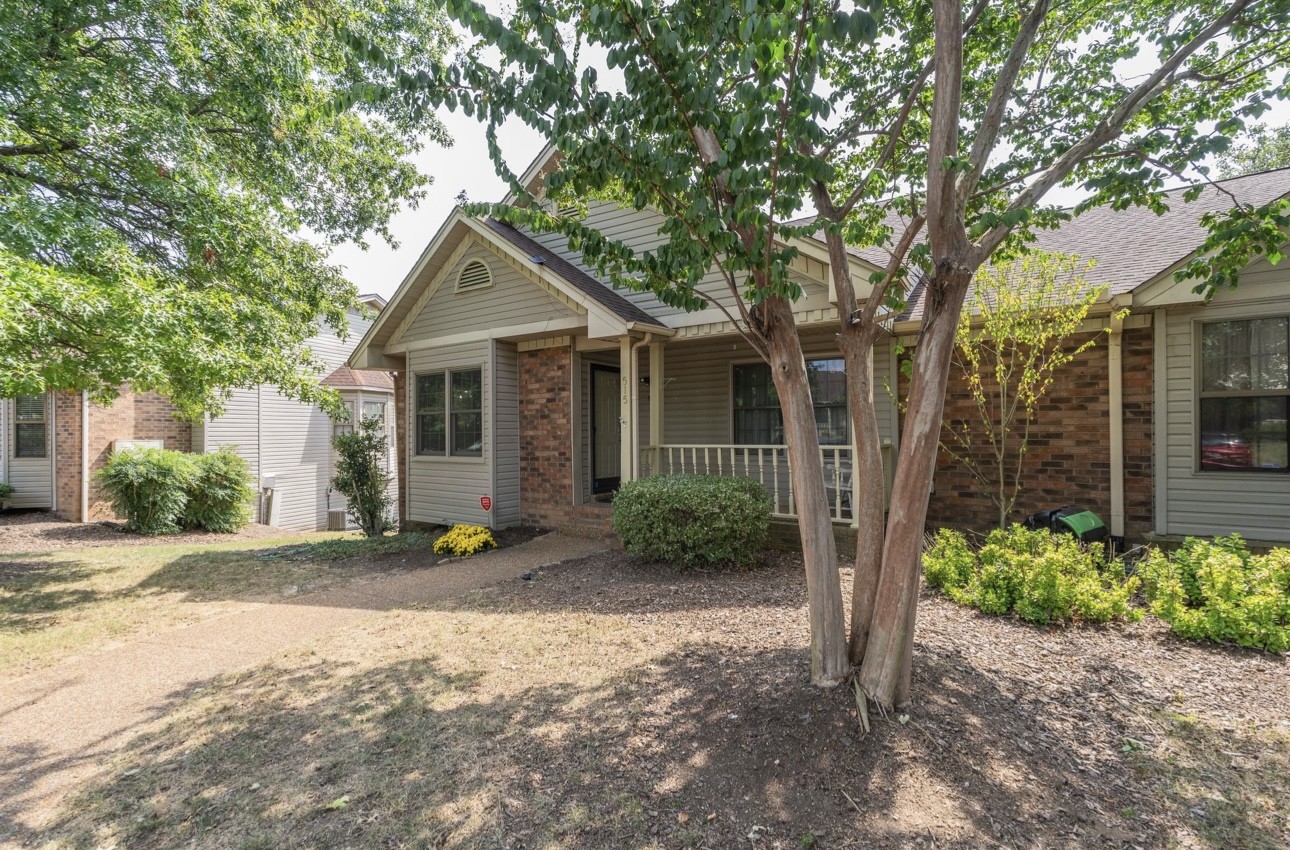 515 Upsall Drive Antioch, TN 37013 - Photo 2 of 31 a front view of a house with a yard and potted plants