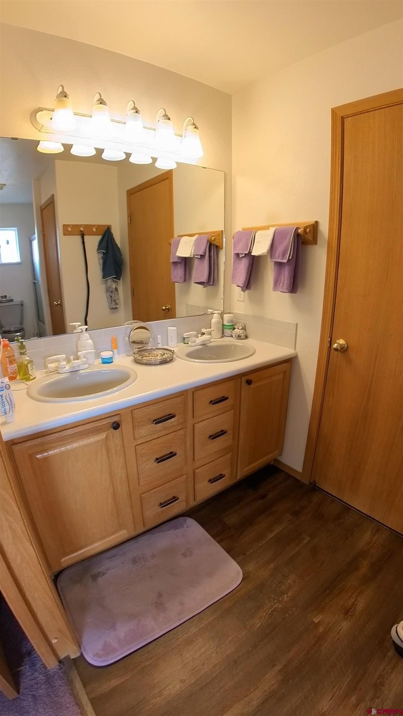 16709 Cedar Lane Cedaredge, CO 81413 - Photo 16 of 35 a bathroom with a double vanity sink and mirror