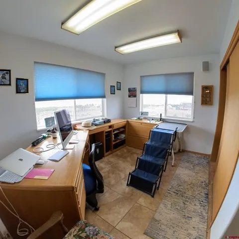 a living room with furniture a window and gym equipment