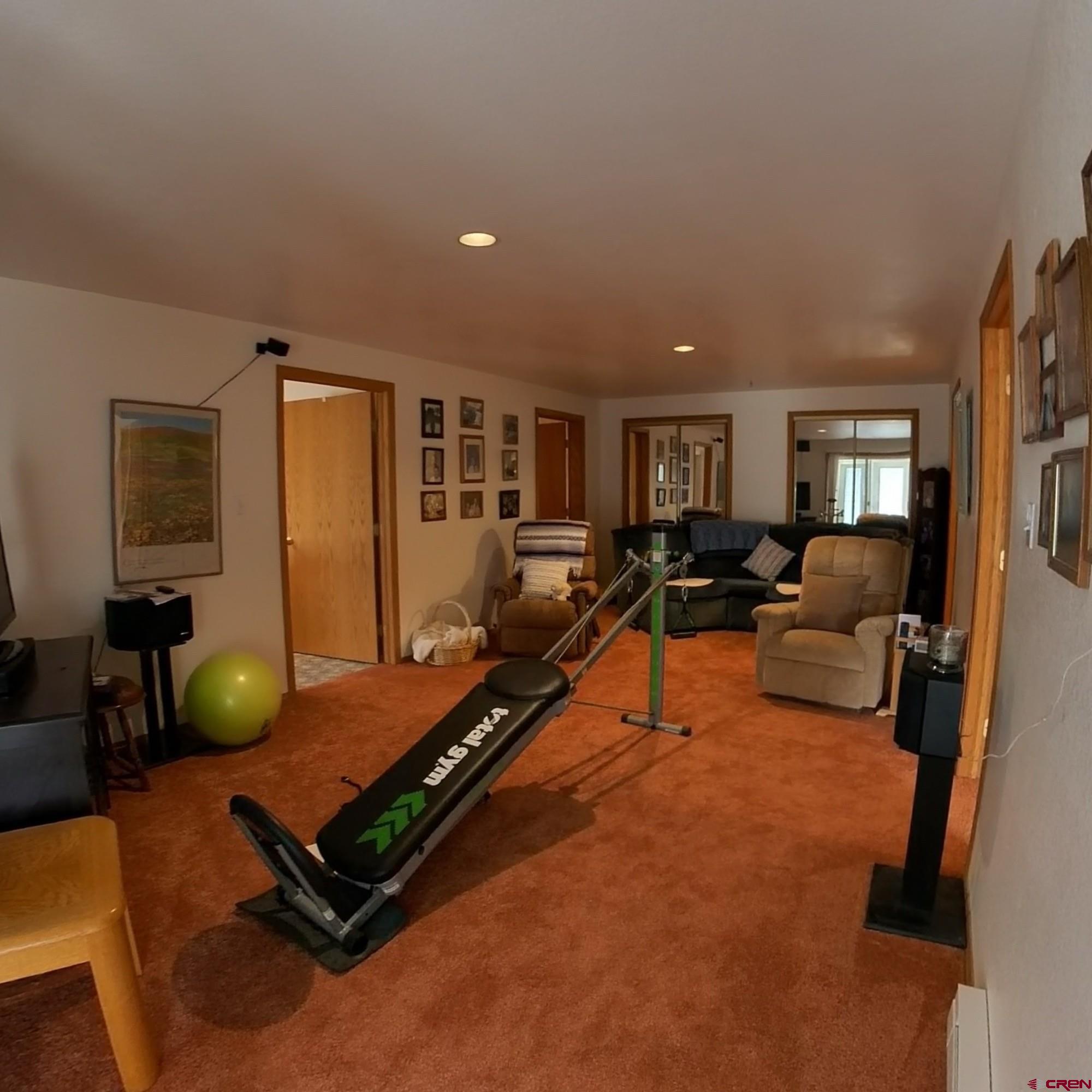 16709 Cedar Lane Cedaredge, CO 81413 - Photo 18 of 35 a living room with furniture a window and gym equipment
