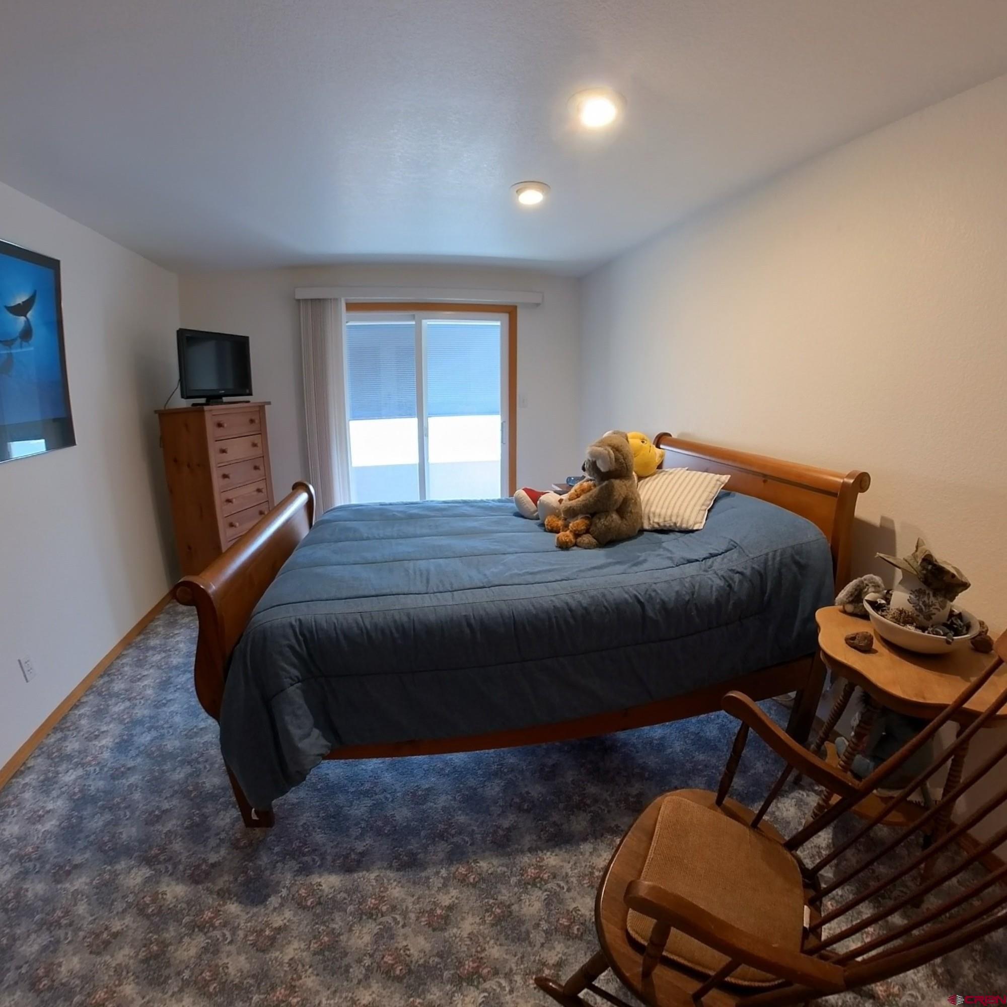 16709 Cedar Lane Cedaredge, CO 81413 - Photo 22 of 35 a bedroom with a bed and wooden floor
