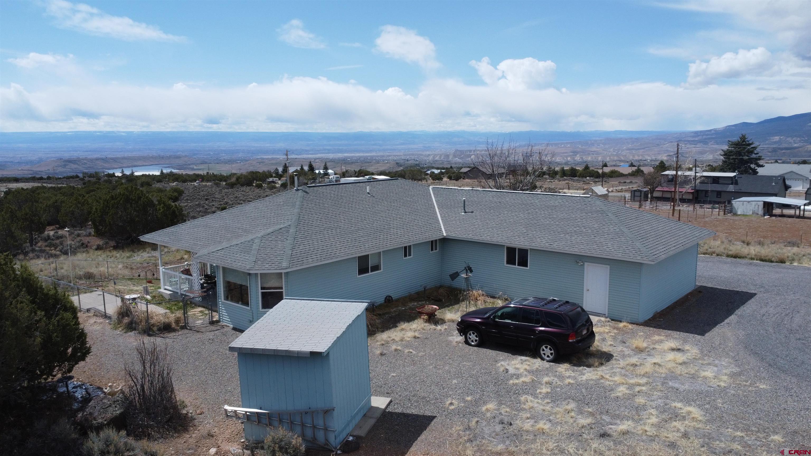 16709 Cedar Lane Cedaredge, CO 81413 - Photo 29 of 35 an aerial view of a house with a garden and lake view