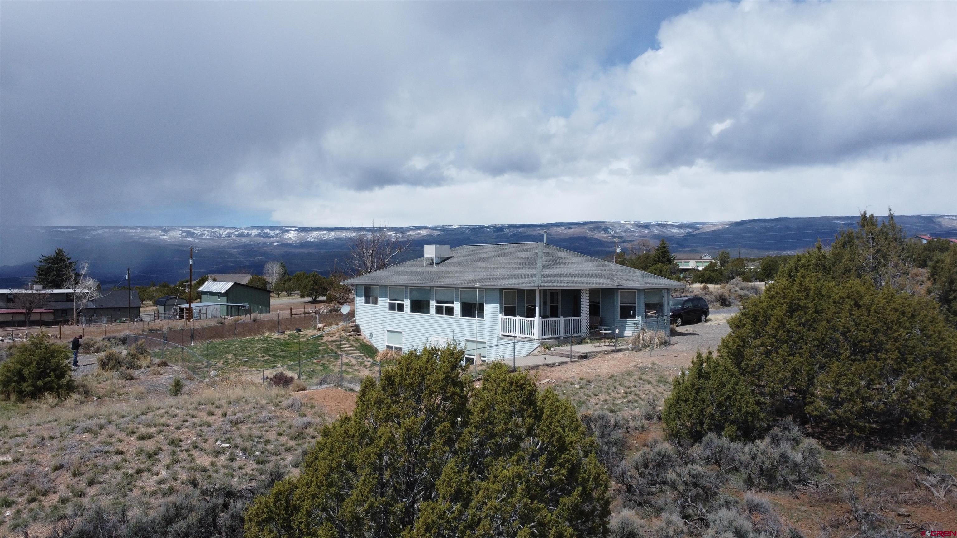 16709 Cedar Lane Cedaredge, CO 81413 - Photo 33 of 35 an aerial view of a house with yard and trees in front of it