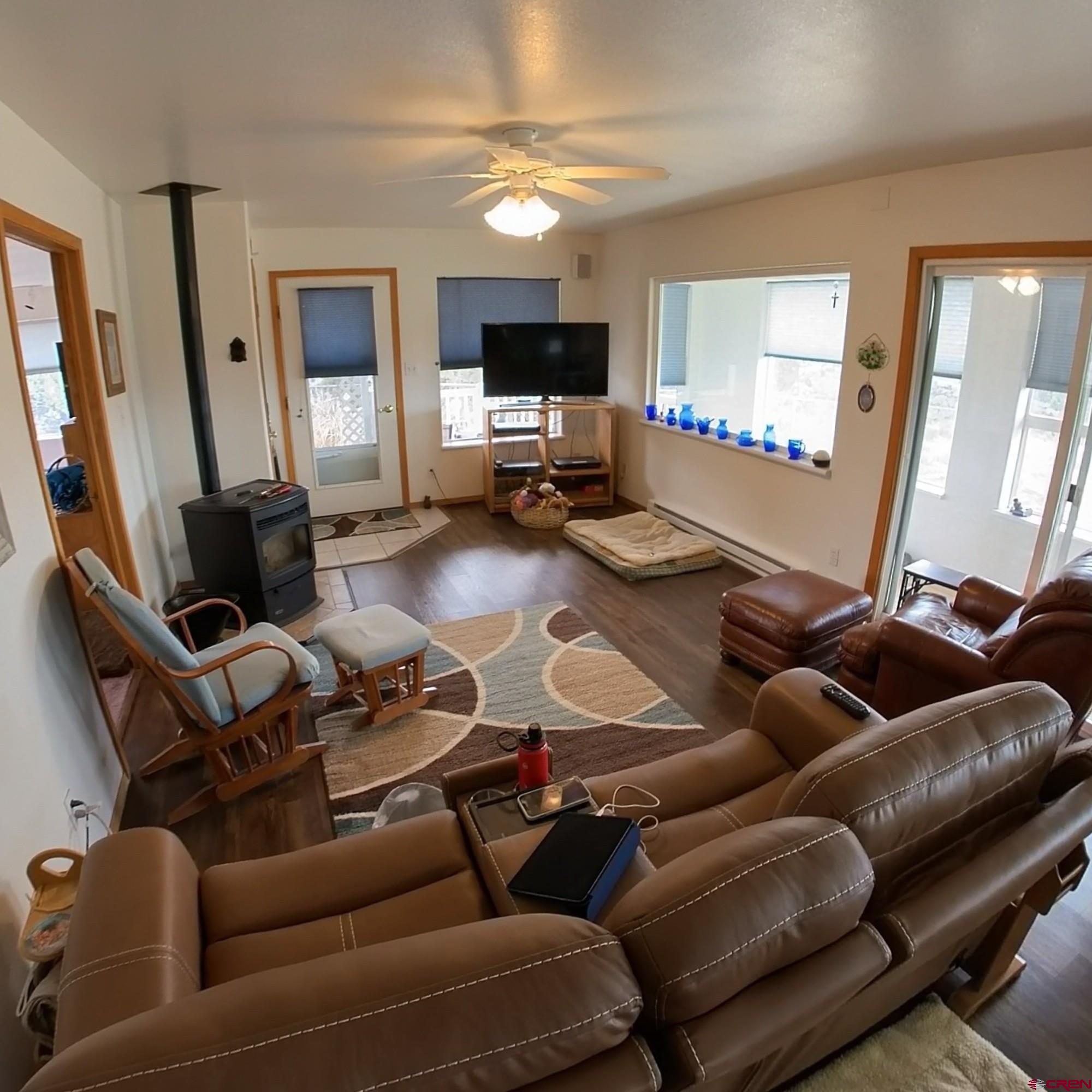 16709 Cedar Lane Cedaredge, CO 81413 - Photo 8 of 35 a living room with furniture and a flat screen tv