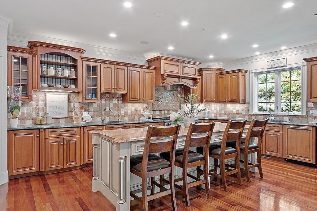 102 Claybrook Road Dover, MA 02030 - Photo 12 of 42 a kitchen with granite countertop wooden floors and wooden cabinets