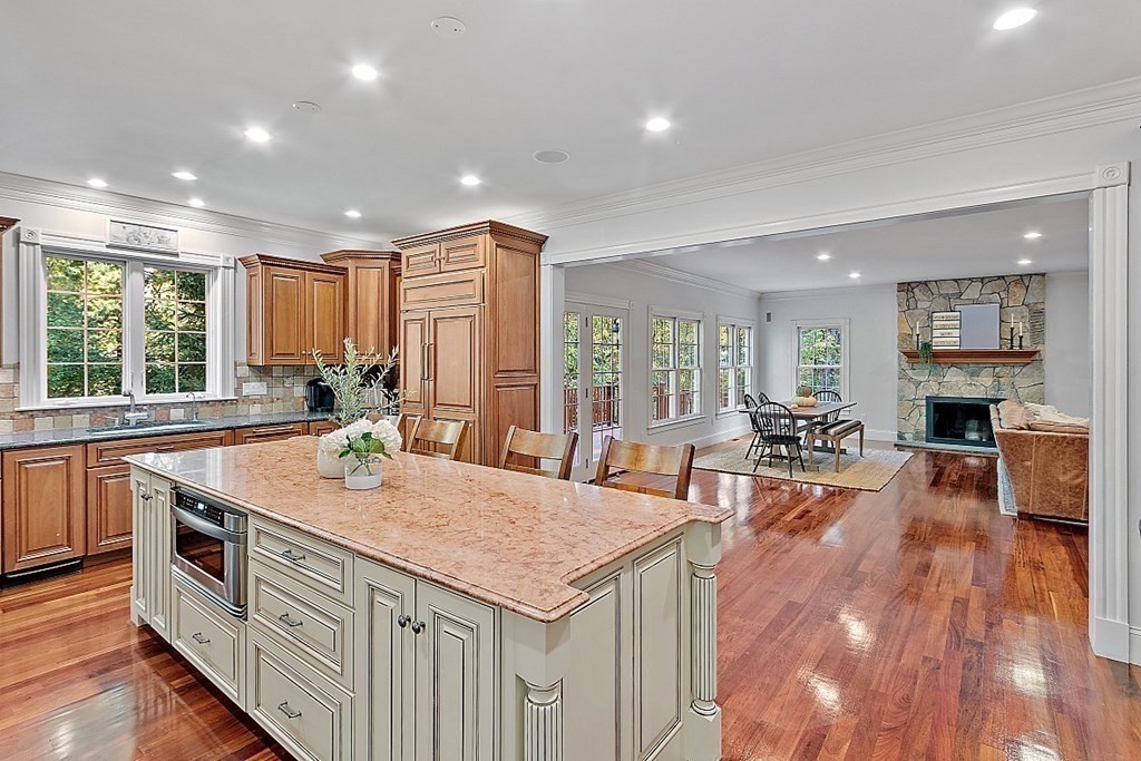 102 Claybrook Road Dover, MA 02030 - Photo 14 of 42 a open kitchen with stainless steel appliances granite countertop a sink a stove and wooden floor