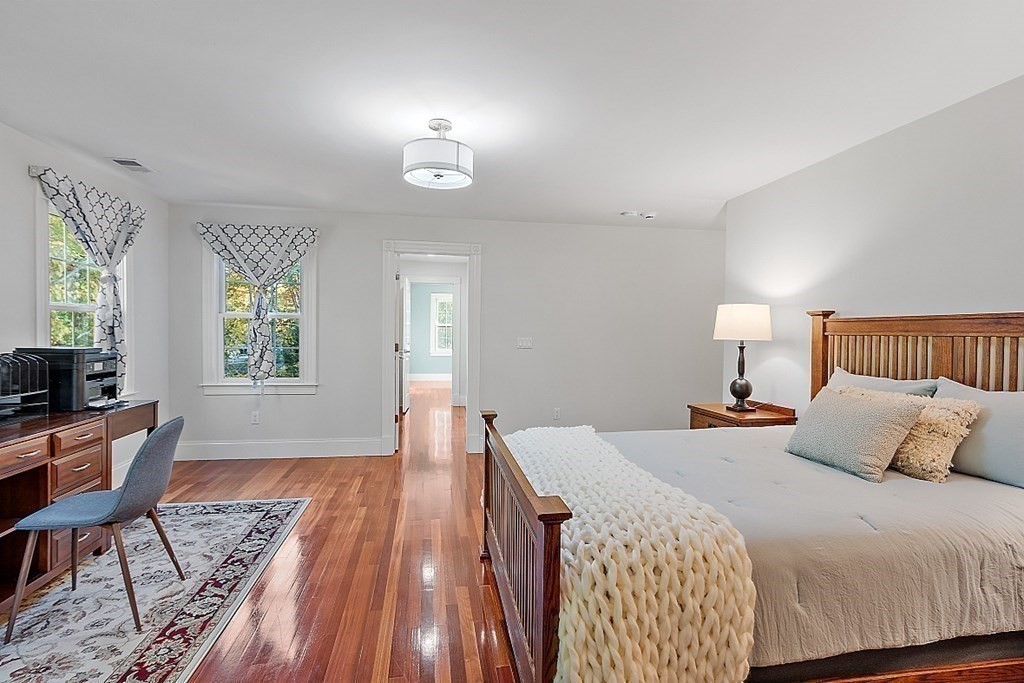 102 Claybrook Road Dover, MA 02030 - Photo 28 of 42 a bedroom with a bed and wooden floor