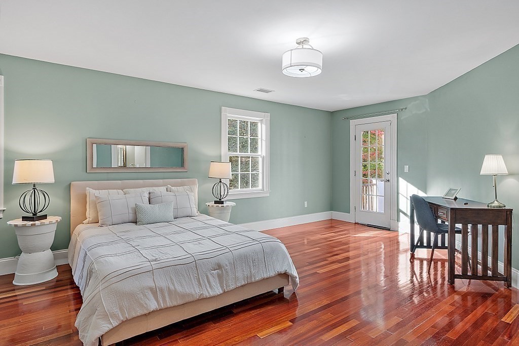 102 Claybrook Road Dover, MA 02030 - Photo 30 of 42 a bedroom with a bed and wooden floor