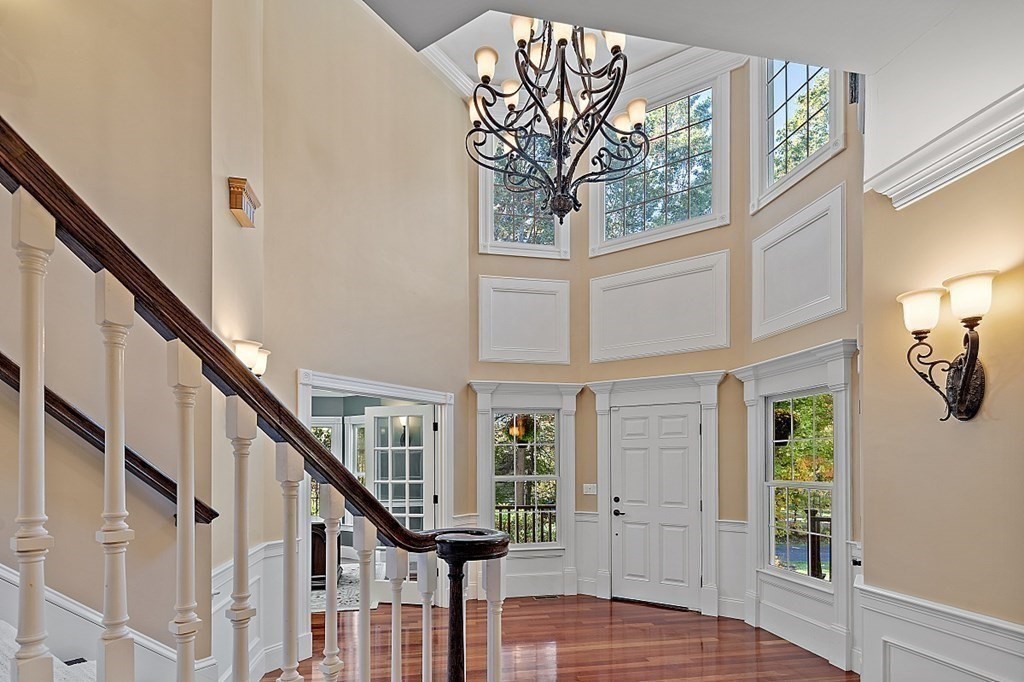 102 Claybrook Road Dover, MA 02030 - Photo 6 of 42 a view of staircase with lots of frames on wall and a window