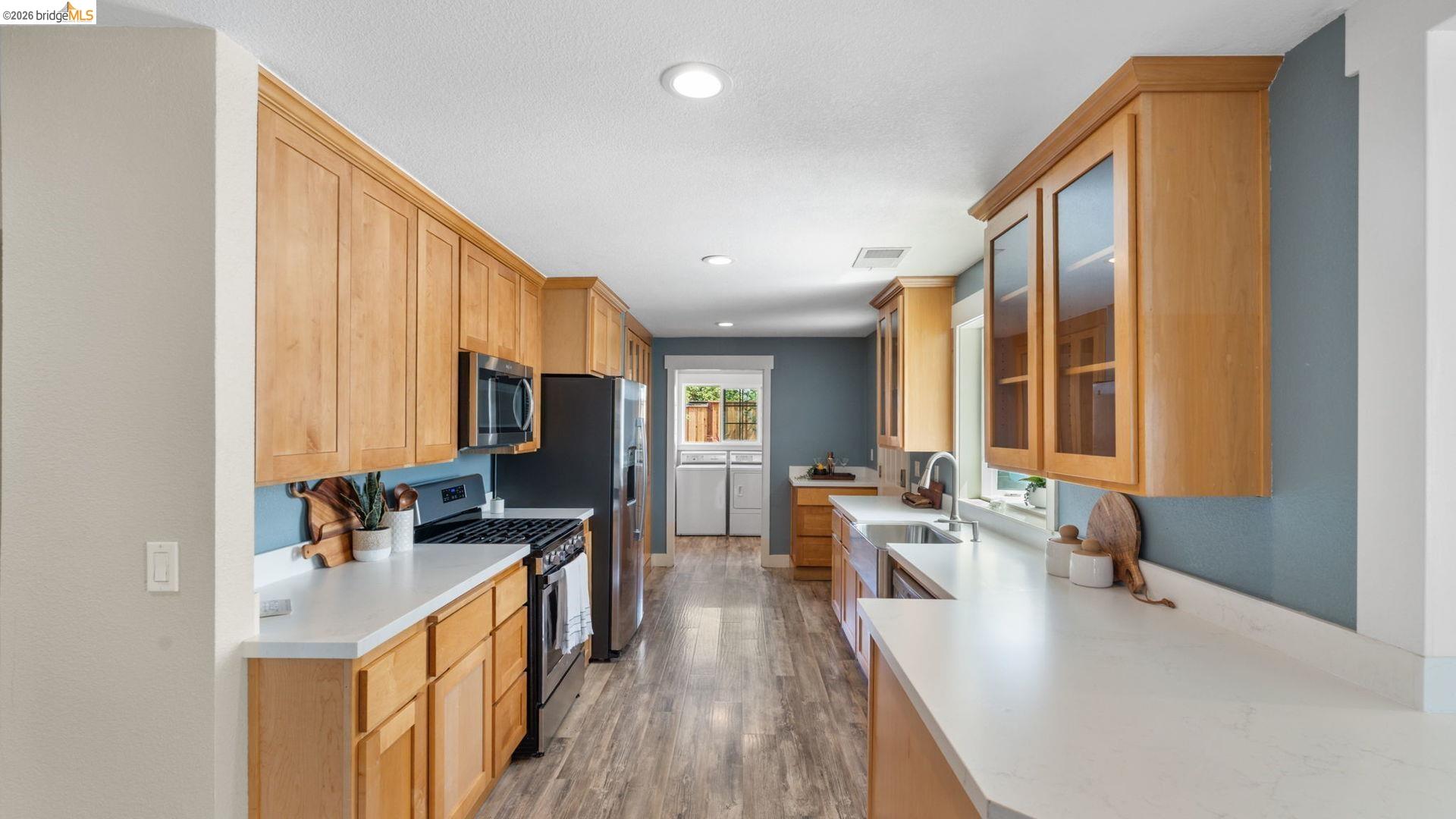 700 Brownstone Road Oakley, CA 94561 - Photo 21 of 58 a kitchen with counter top space a sink and appliances