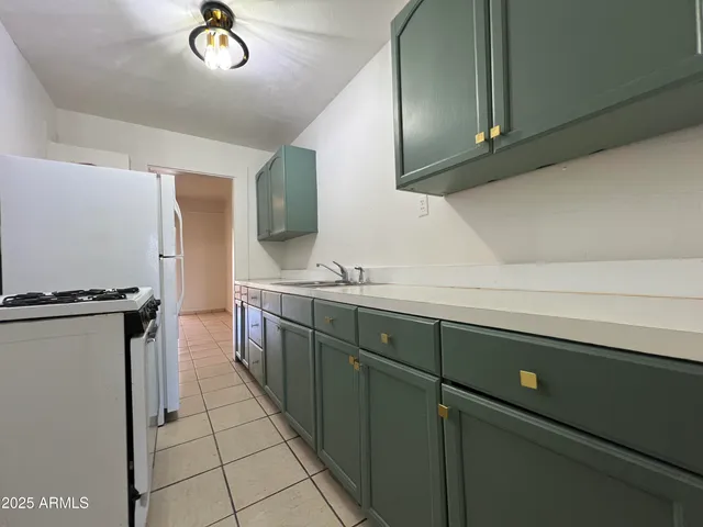 a kitchen with a refrigerator and a sink