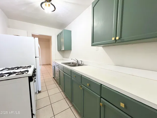 a kitchen with a sink and a stove top oven