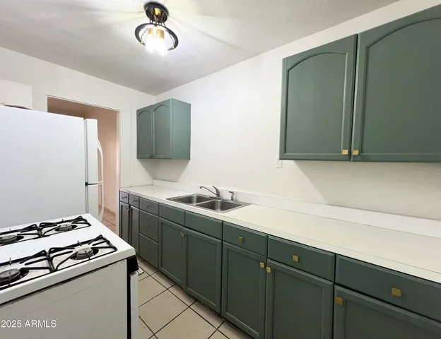 a kitchen with a stove and a sink