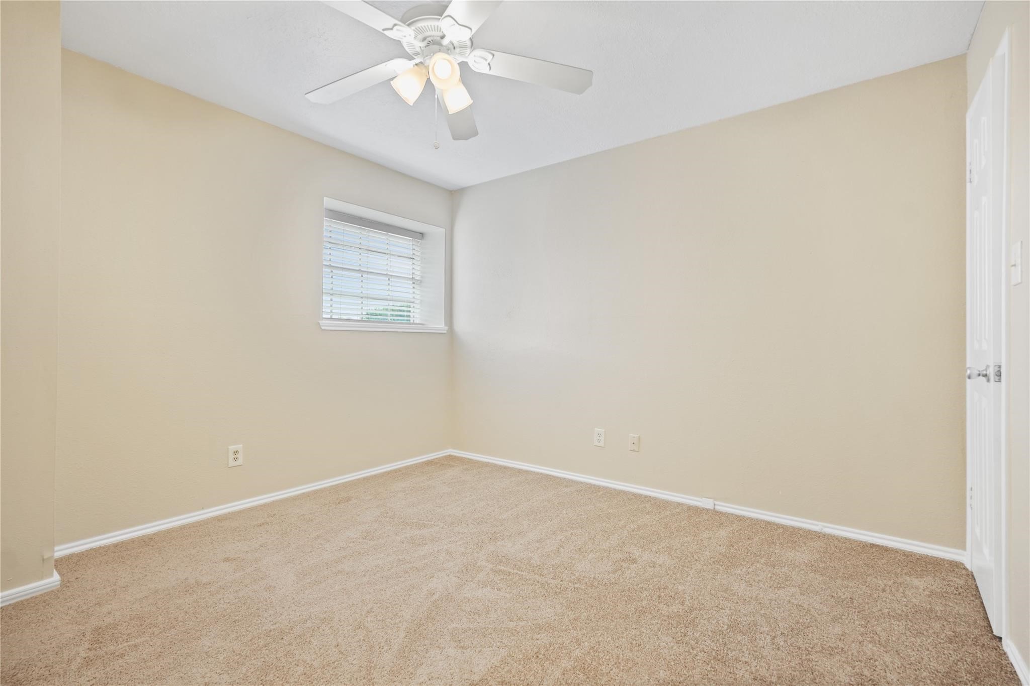 22911 Sherioaks Lane Spring, TX 77389 - Photo 18 of 22 an empty room with a window and a fan