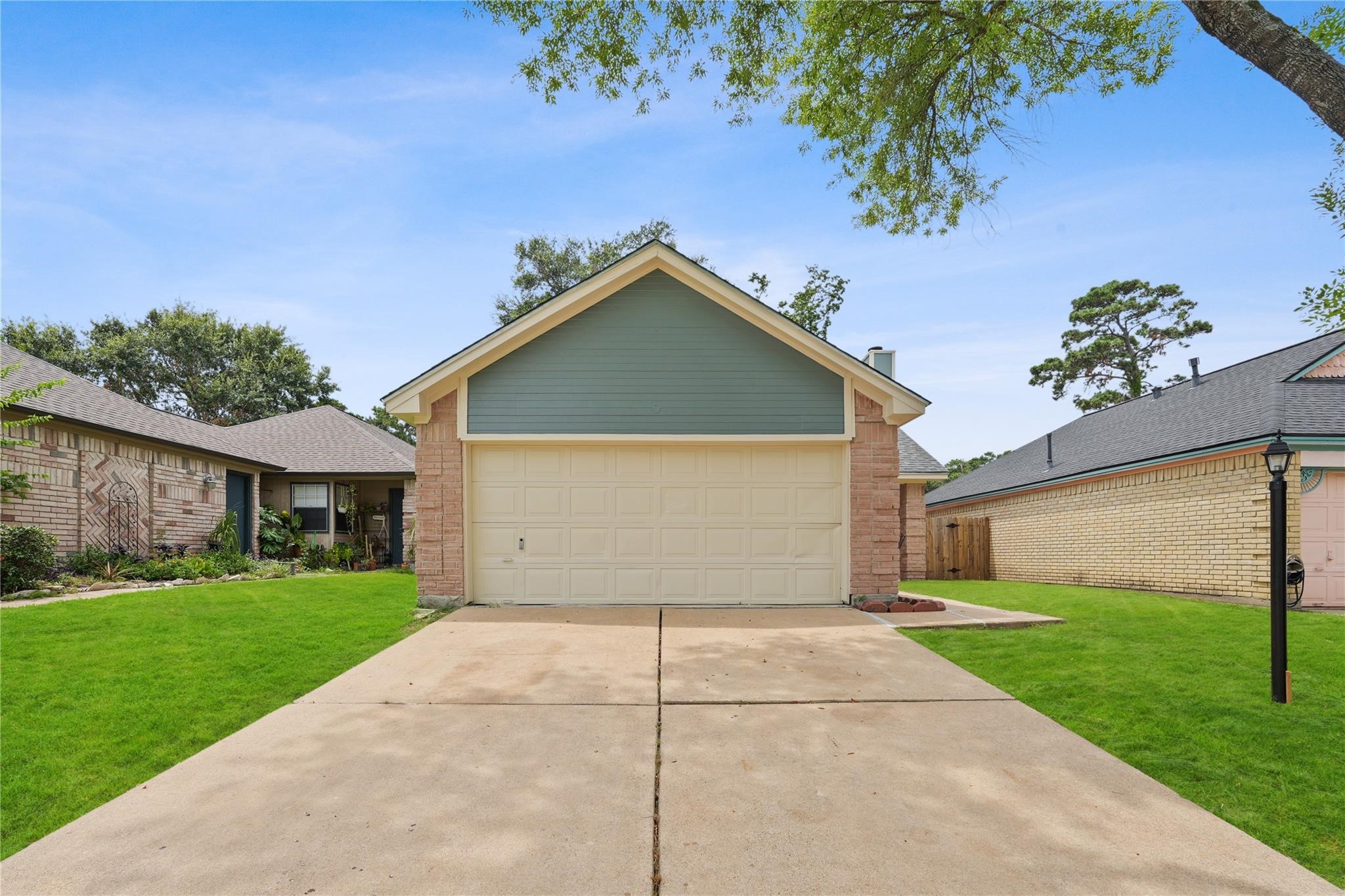 22911 Sherioaks Lane Spring, TX 77389 - Photo 3 of 22 a front view of a house with a yard and garage
