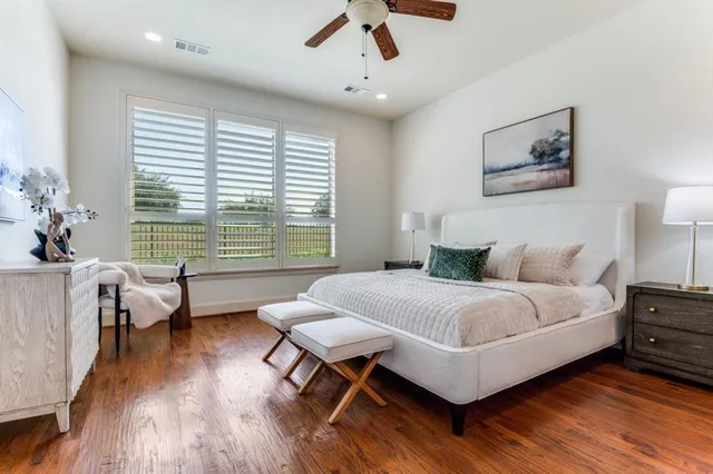 a spacious bedroom with a bed and a large window