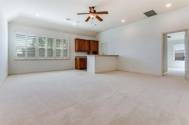 a view of empty room with ceiling fan