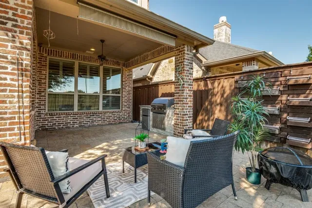 a view of a patio with a table and chairs