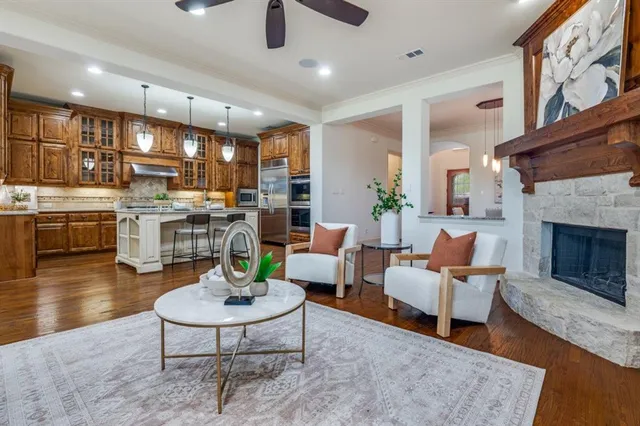 a living room with fireplace furniture and a wooden floor