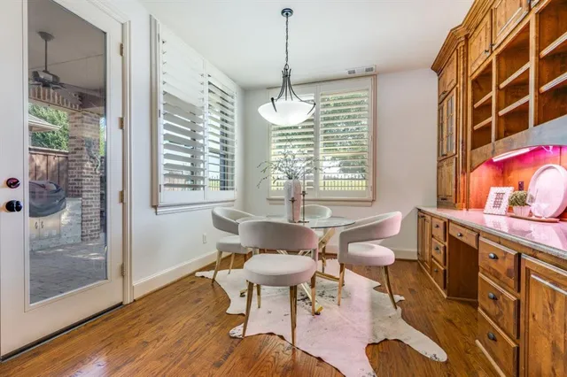 a dining room with furniture and wooden floor