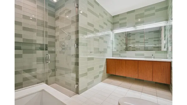 a bathroom with a granite countertop sink a toilet and shower