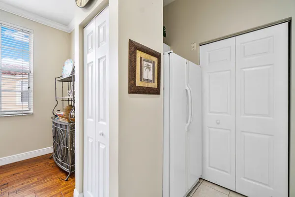 a bedroom with a bed and a flat tv screen on dresser