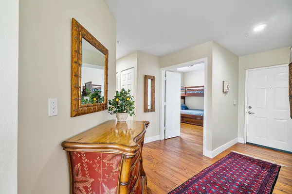 a view of a hallway to a livingroom with furniture