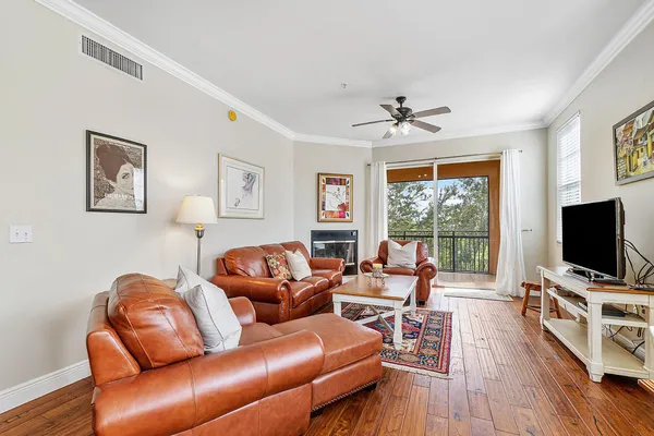 a living room with furniture flat screen tv and wooden floor