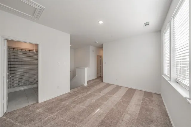 a view of an empty room and a window