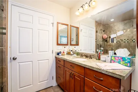a bathroom with a sink vanity and mirror