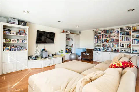 a bedroom with a bed window and book shelf