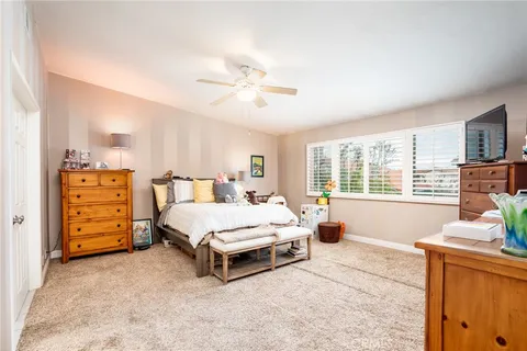 a spacious bedroom with a bed and a window