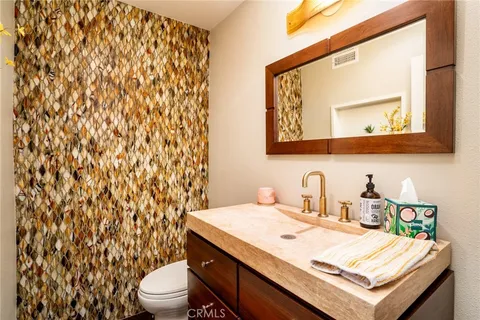 a bathroom with a sink toilet and mirror