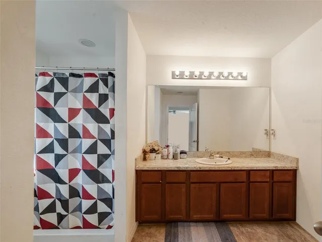 a bathroom with a double vanity sink and mirror