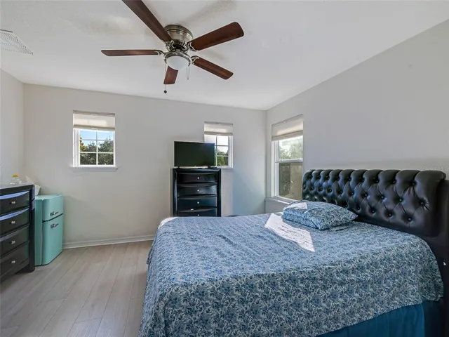 a bedroom with a bed and a tv