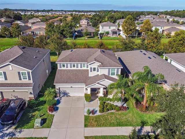 an aerial view of multiple houses with a yard